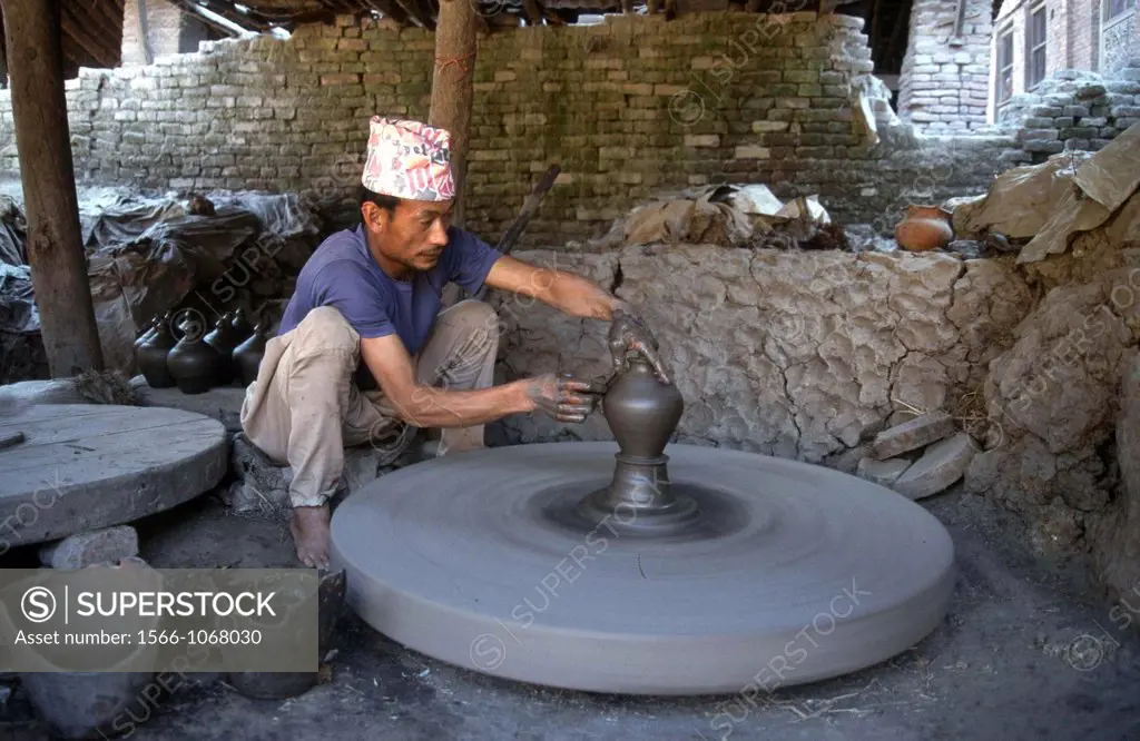 A man is making a clay pot for storing food and oils in Baktapur