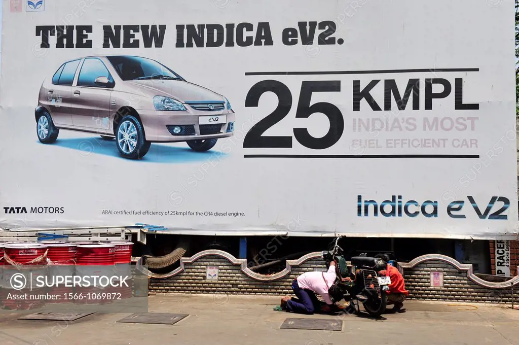 Car advertisement for Tata motors,men repair motorcycle in Puducherry Pondichery,Tamil Nadu,South India,Asia