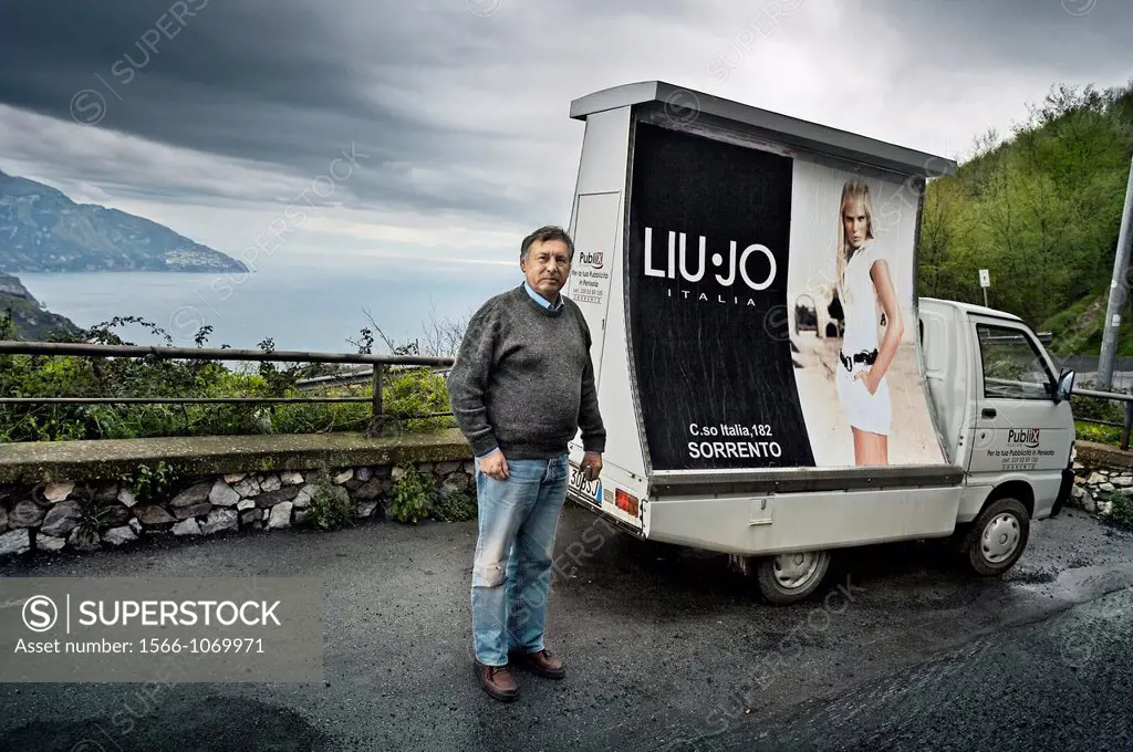 man with his advertisement van, Naples Bay, Naples, Campania, Italy.