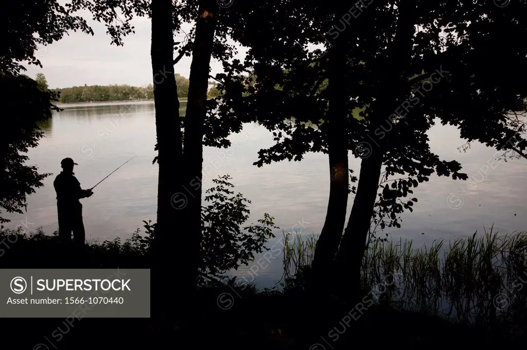 fisherman in the lake Gatvé, in the lithuanian rgion of Trakai  Lithuania