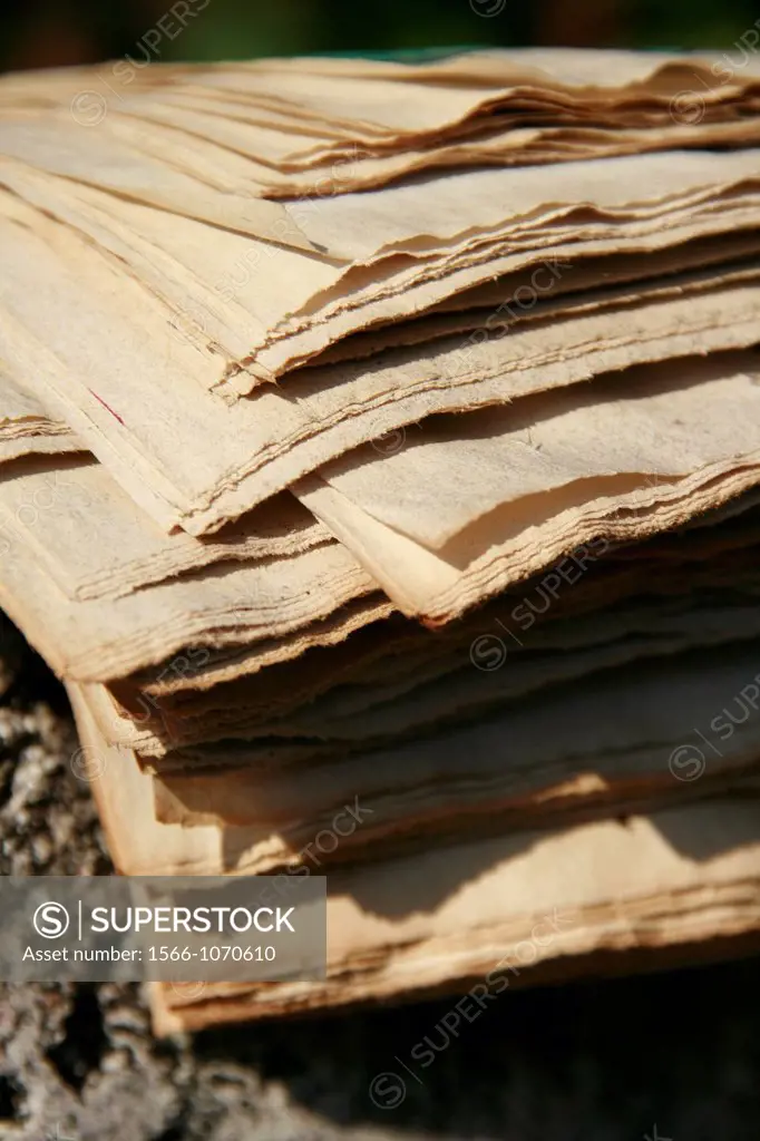 pile of old faded newspapers outdoors in sun