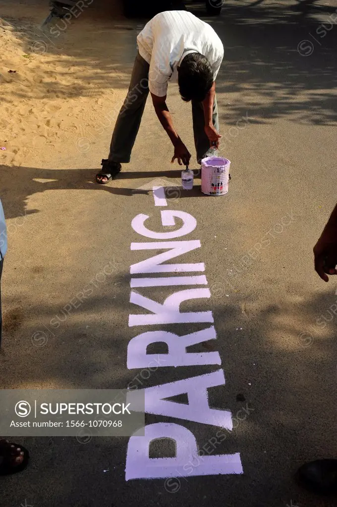 Indian man painting on asphalt in Puducherry Pondichery,Tamil Nadu,South India,Asia