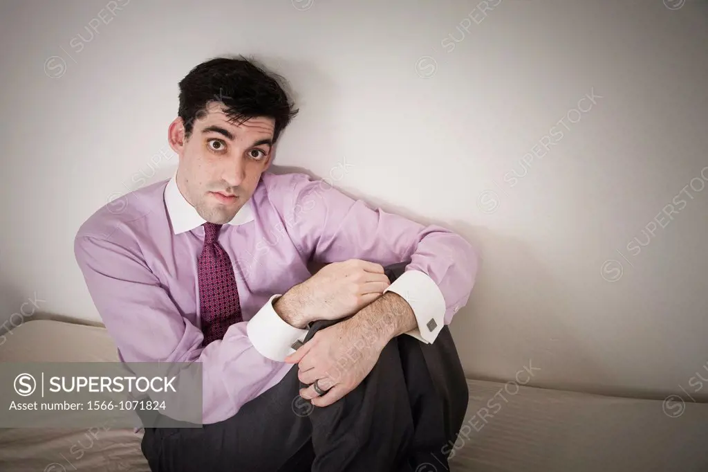 Man sitting on his bed