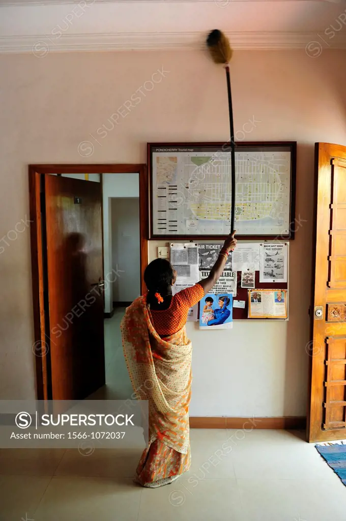 Indian woman cleaning the entrance of guesthouse in Puducherry Pondichery,Tamil Nadu,South India,Asia