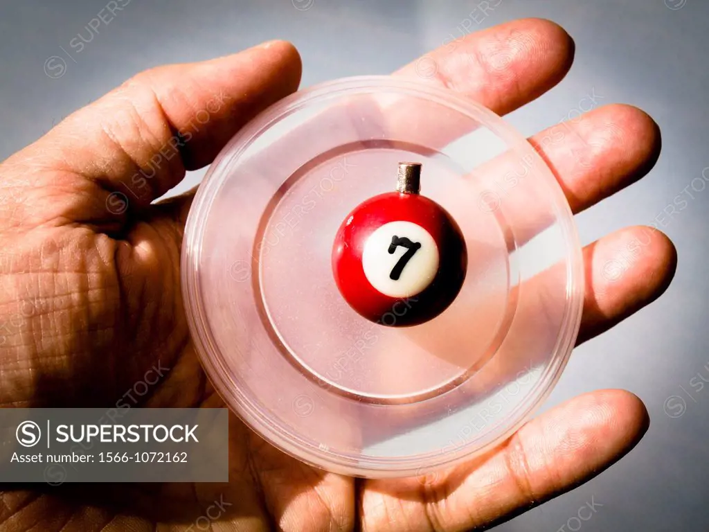 Number 7. Ball on a circular plastic held by a hand.