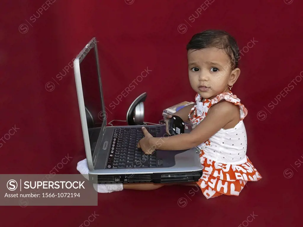 Baby playing with laptop computer