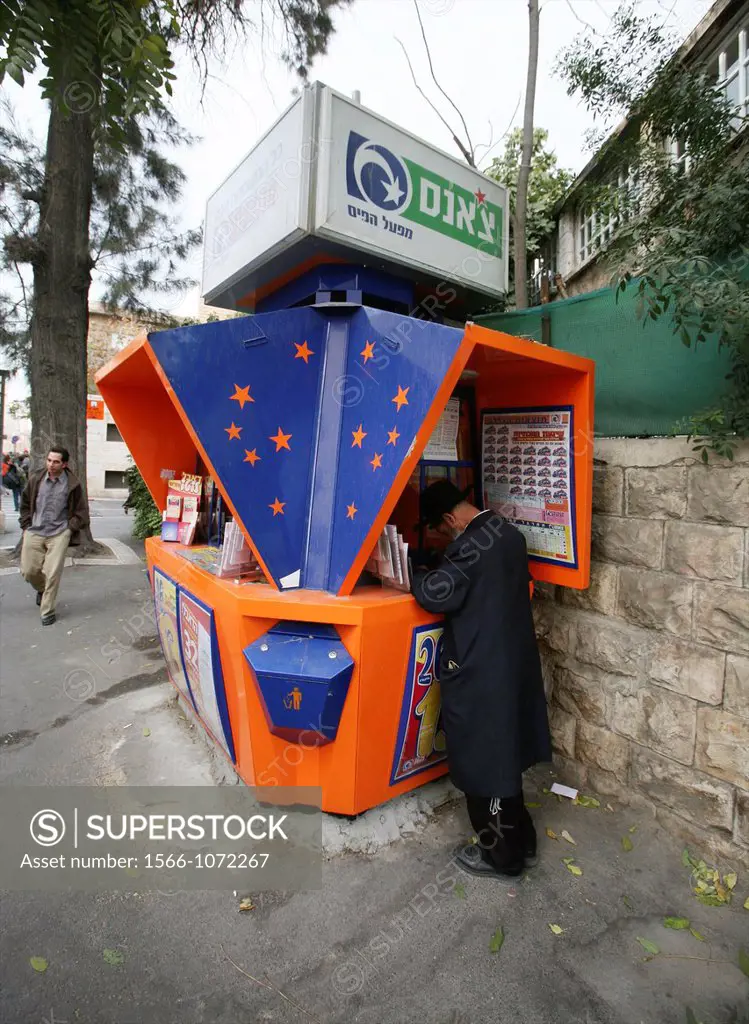 An orthodox Jew buys a lottery ticket near the market in the old city of Jerusalem