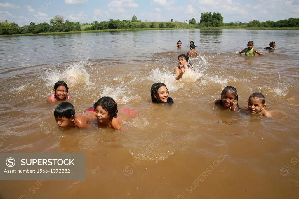 River Magdalena is the main water and transportway between Bogota and the ocean Children playing in the river but the water is heavily polluted