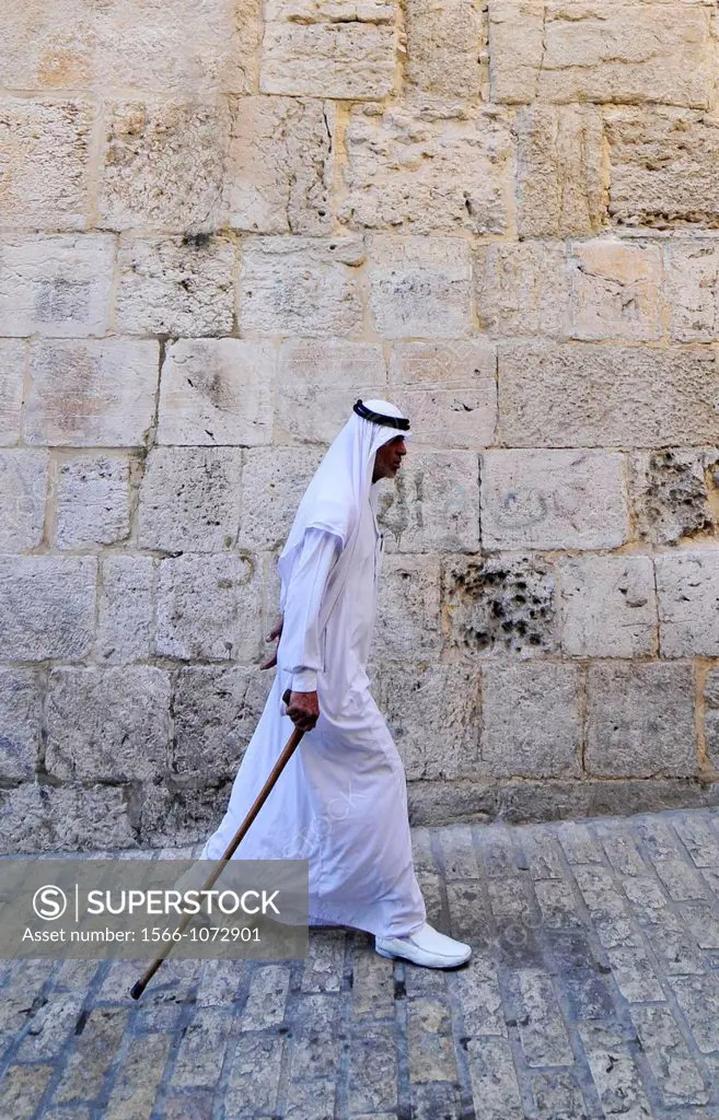 A Bedouin man dressed in traditional Jalaba walking in the old city of Jerusalem