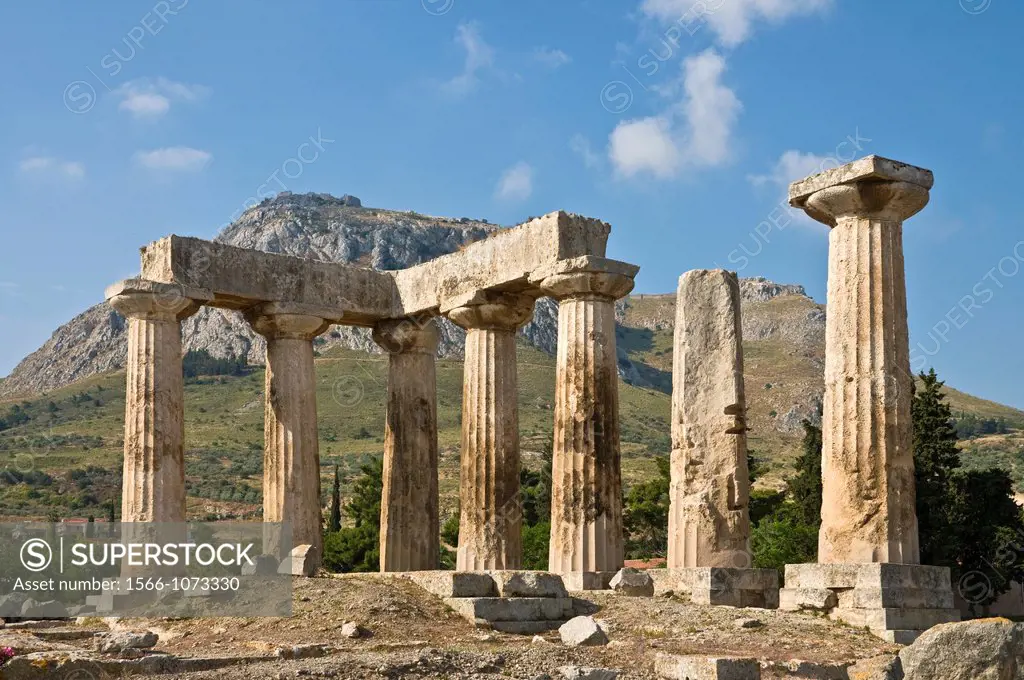 The 5th cen  BC Temple of Apollo at Ancient Corinth with the rock of Acrocorinth, the ancient Acropolis of Corinth, in the background, Peloponnese, Gr...