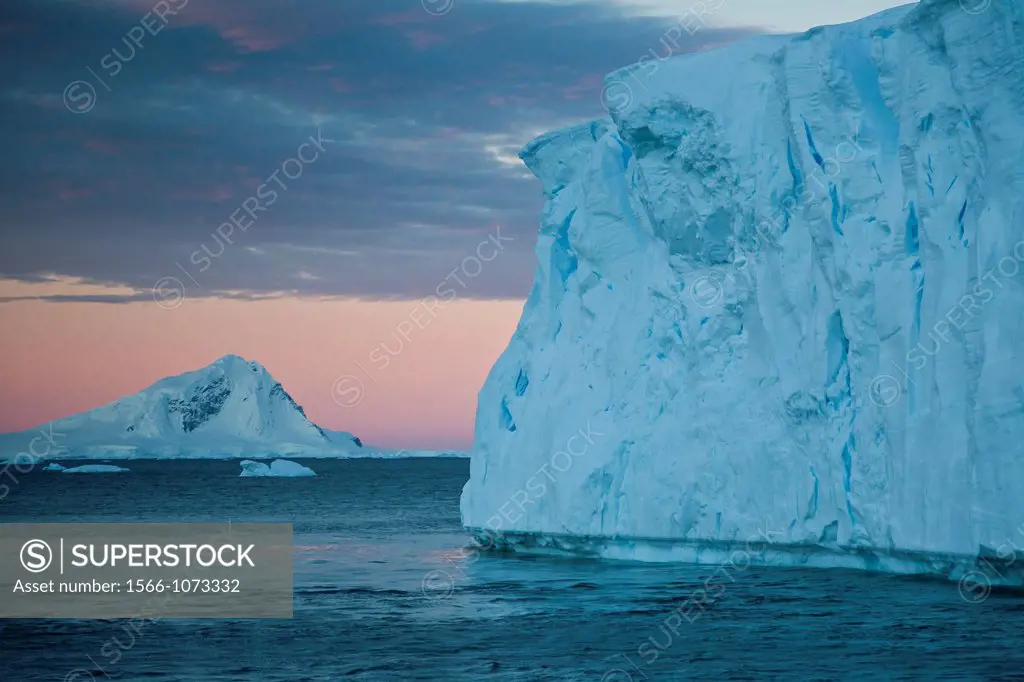 Views of tabular icebergs near Adelaide Island at sunset in Antarctica