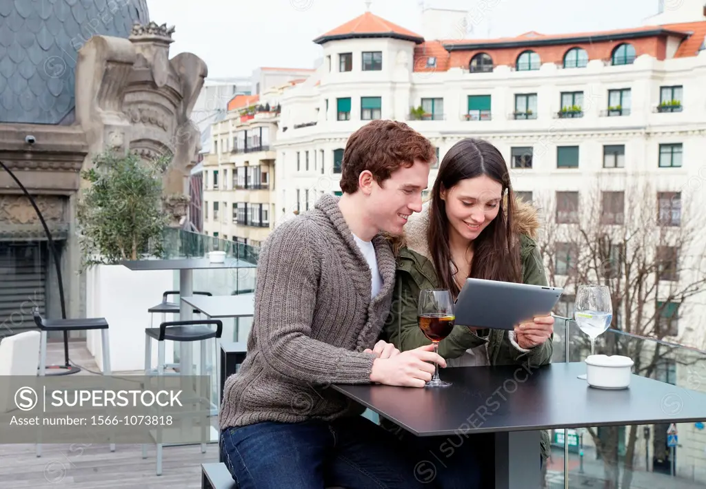 Young couple with digital tablet, digital tablet, Urban terrace bar, Alhondiga building, leisure and culture center, Bilbao, Bizkaia, Basque Country, ...