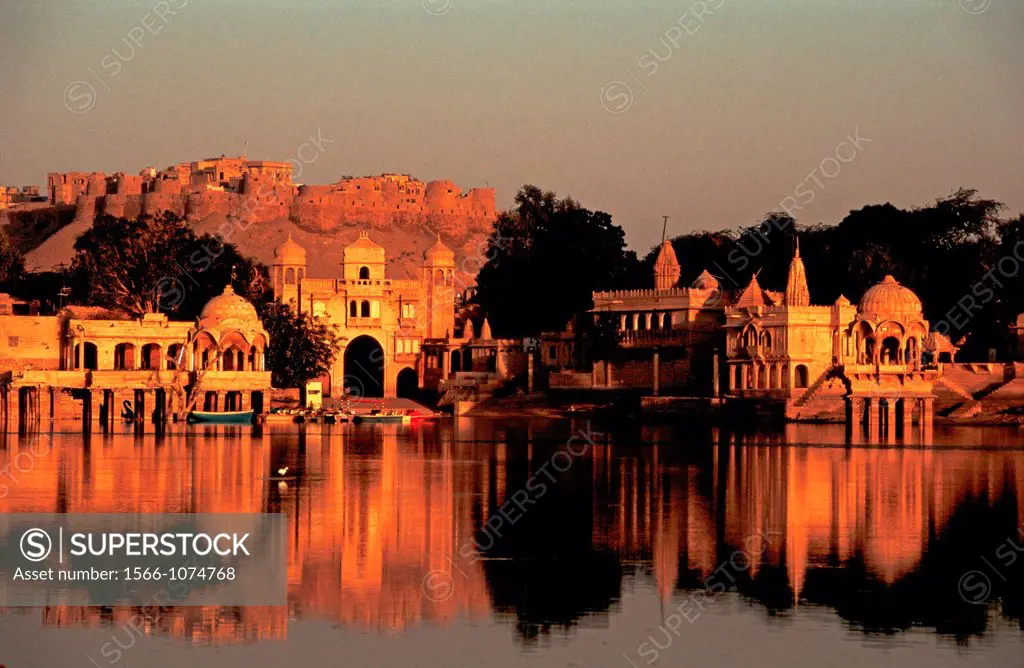 Gadisar lake surrounded by temples. In the background, Jaisalmer fort. At Jaisalmer, India.