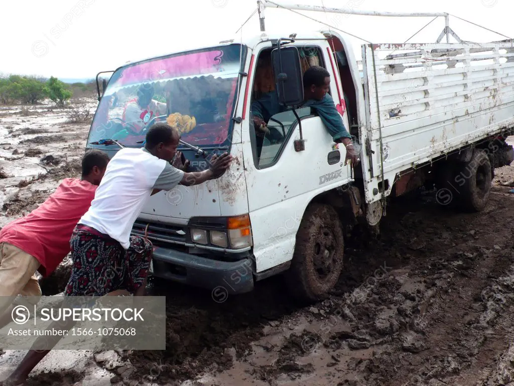 Due to the bad roads all the cars get stuck in the mud and passengers must help. Ethiopia