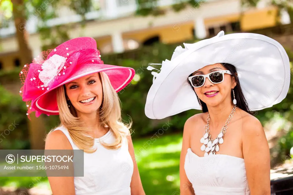 Two young women in their Easter finest gather for the annual Hat Ladies Easter Promenade April 7, 2012 in historic Charleston, South Carolina