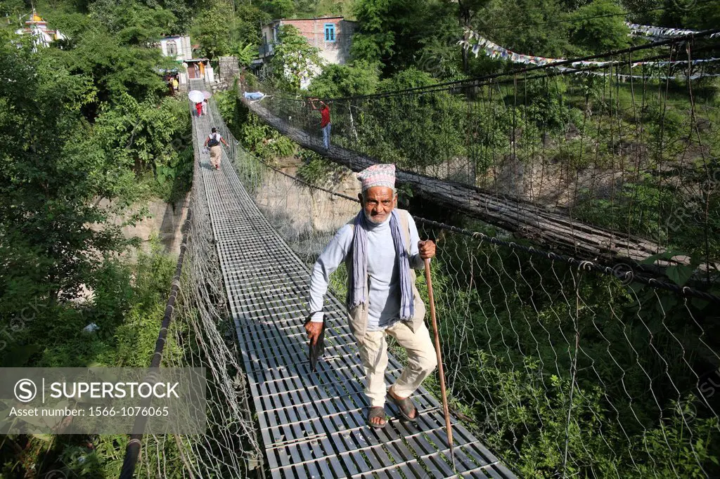 Man crossing suspension bridge, Pokhara