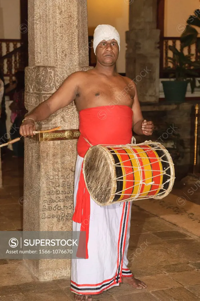 traditional drummer inside the Sacred Temple of the Tooth Relic Dalada Maligawa in Kandy, Sri Lanka