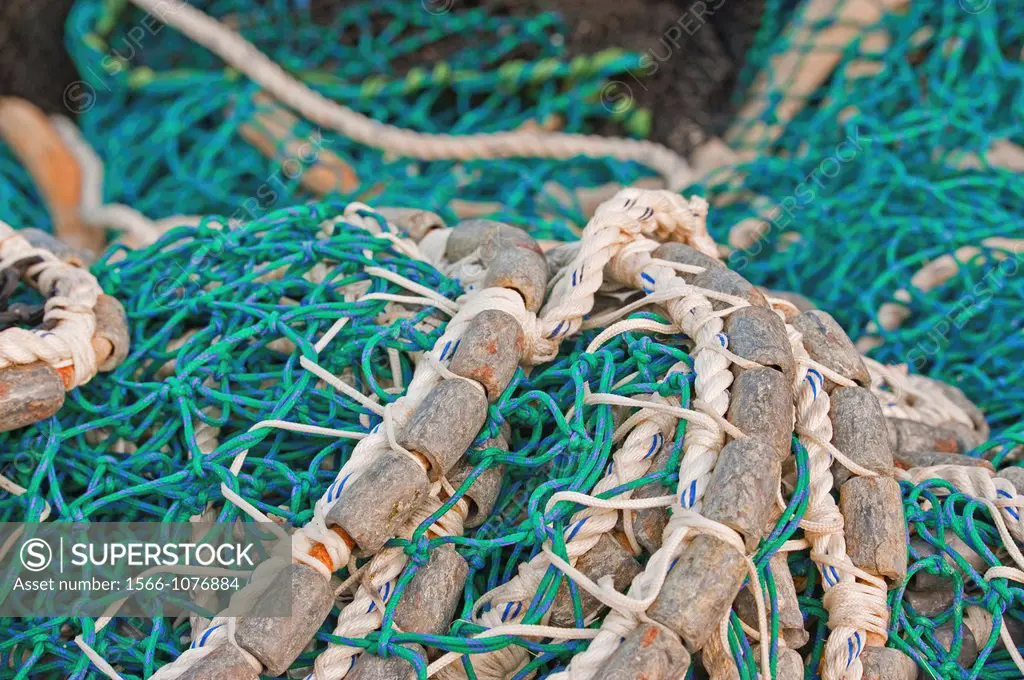 Pacific herring purse seine net and lead line on stack on fishing boat in Sitka, Alaska.