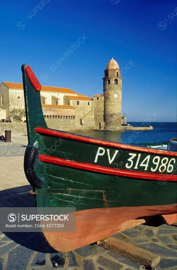 Typical Catalan boat and back Notre Dame des anges church, Port of Collioure, Eastern Pyrenees, Languedoc-Roussillon, France