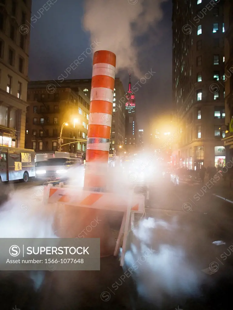 Steam fills the streets a street at dusk in New York, New York, United States
