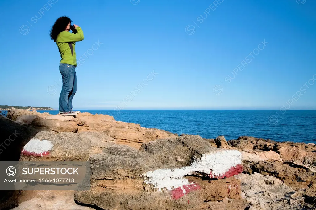 Woman in a GR footpath  Landscape of Perello beach, and Mediterranean sea  Tarragona province  Spain