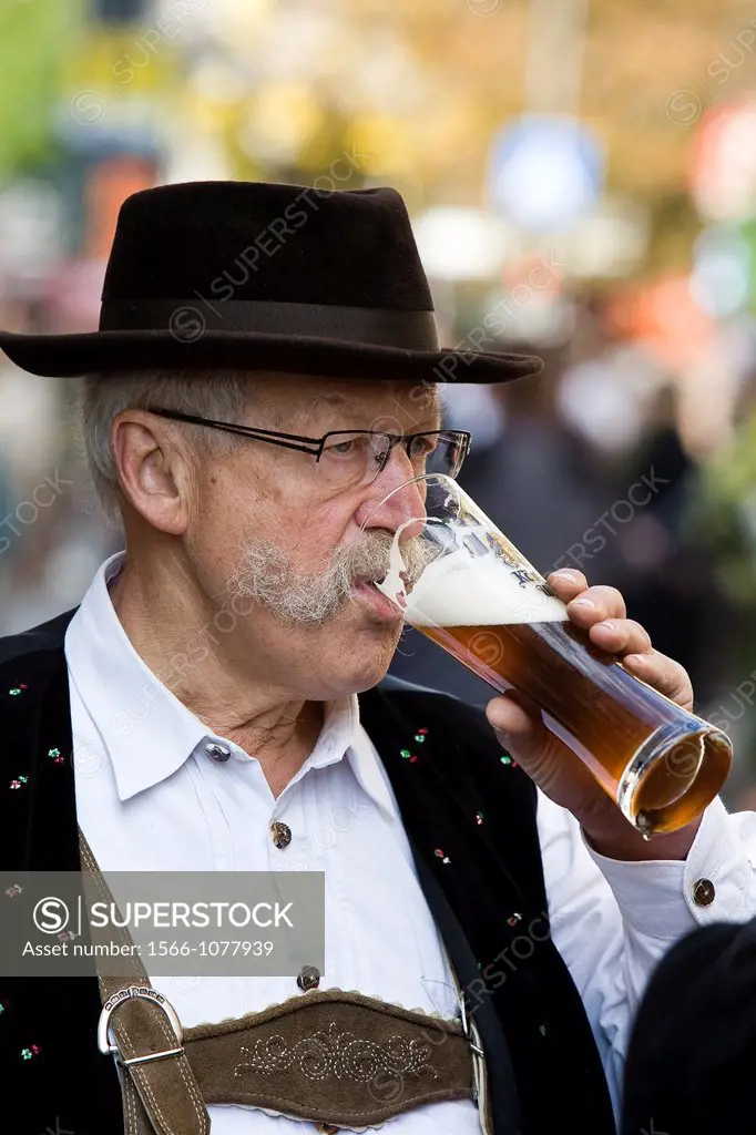 Man drinking beer at the festival opening most famous beer  Oktoberfest, Munich, Bavaria, Germany, Europe