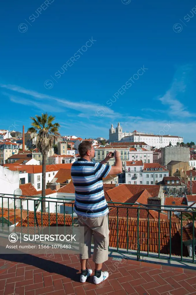 Tourist taking a photo Miradouro de Santa Luzia platform Alfama district central Lisbon Portugal Europe