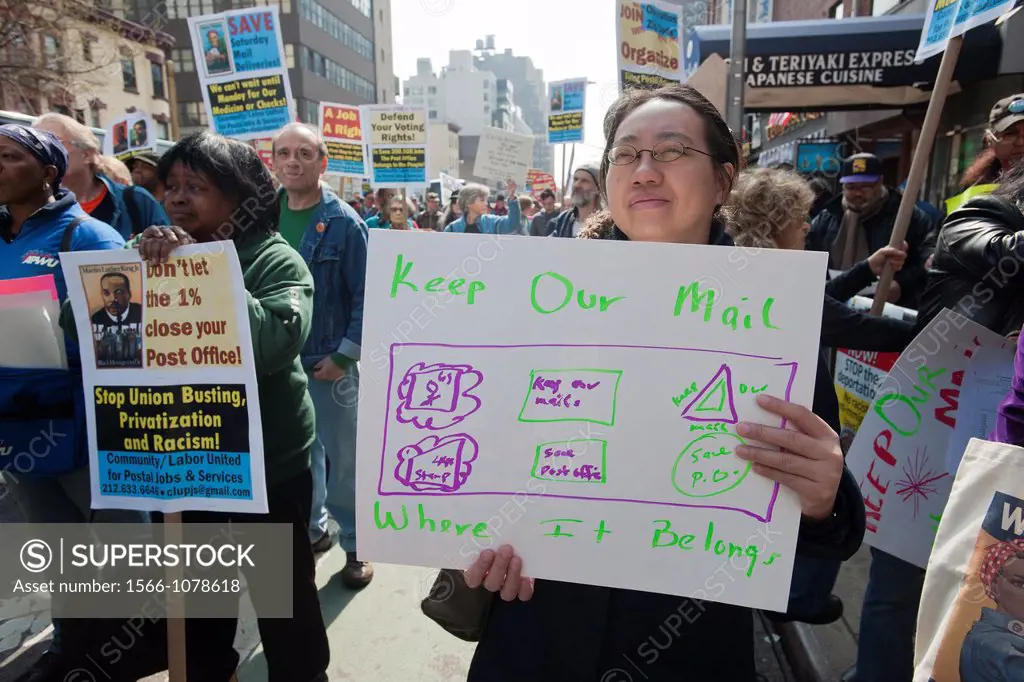 New York Metro Area Postal Union workers and supporters rally near the James Farley Post Office in New York to demand that the USPS continue six-day a...