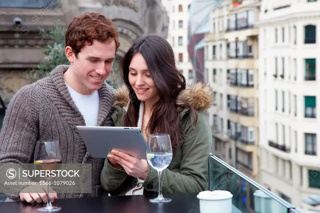Young couple with digital tablet, digital tablet, Urban terrace bar, Alhondiga building, leisure and culture center, Bilbao, Bizkaia, Basque Country, ...