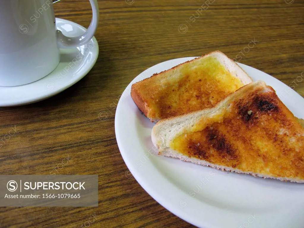toast and cup of tea coffee on table in snack bar cafe