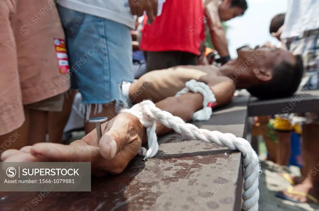 Man being nailed on the cross during the traditional crucifixions, Good Friday, San Fernando, Pampanga, Philippines