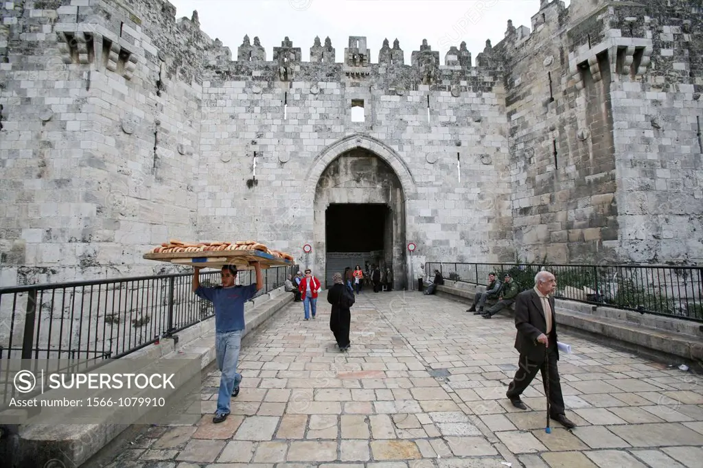 Scenes around the Damascus gate in the old city of Jerusalem A worker carries a tray of bread