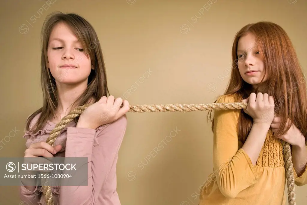 Preteen girls pulling on a rope