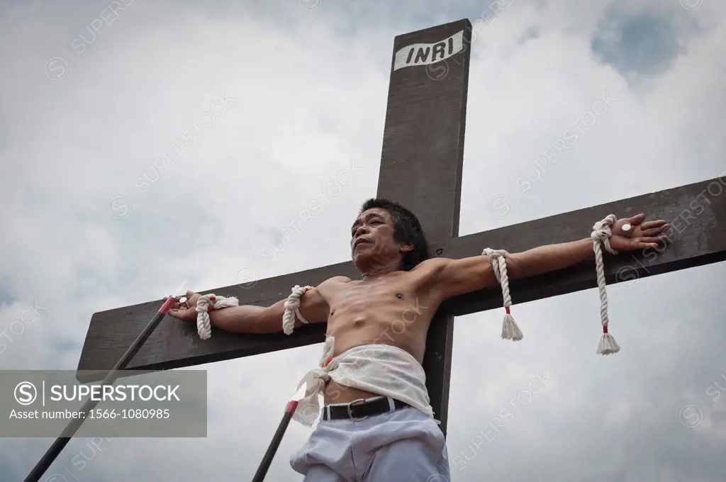 Alex nailed on the cross during the traditional crucifixions, Good Friday, San Fernando, Pampanga, Philippines