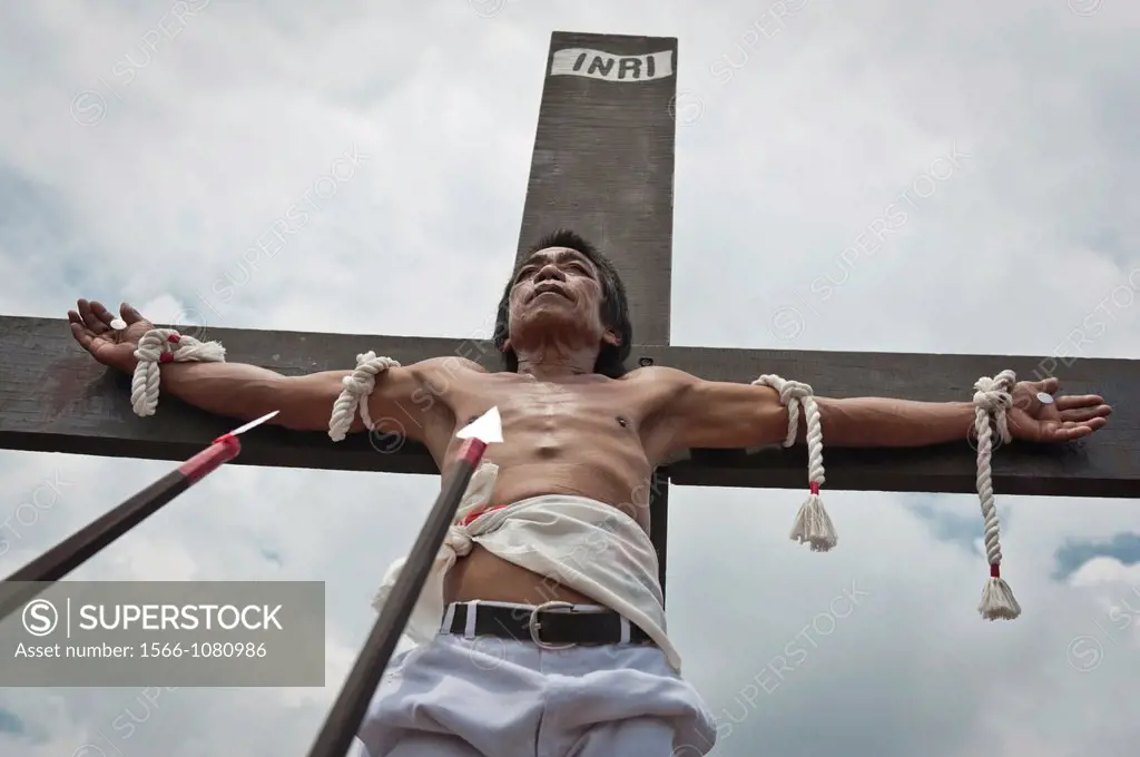 Alex nailed on the cross during the traditional crucifixions, Good Friday, San Fernando, Pampanga, Philippines