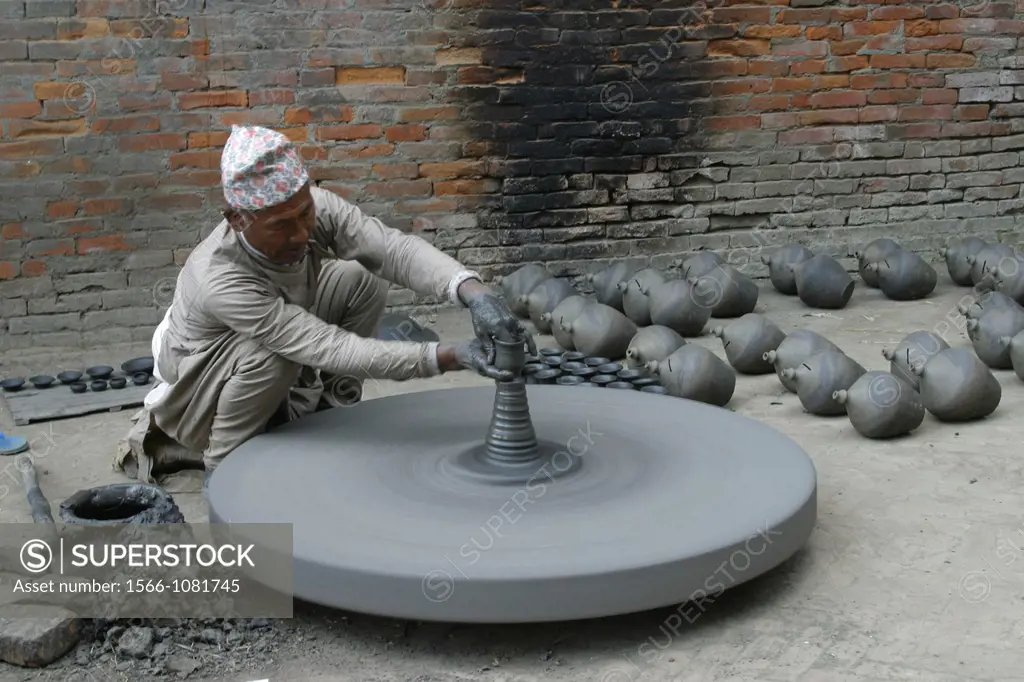 A man is making a clay pot for storing food and oils in Baktapur
