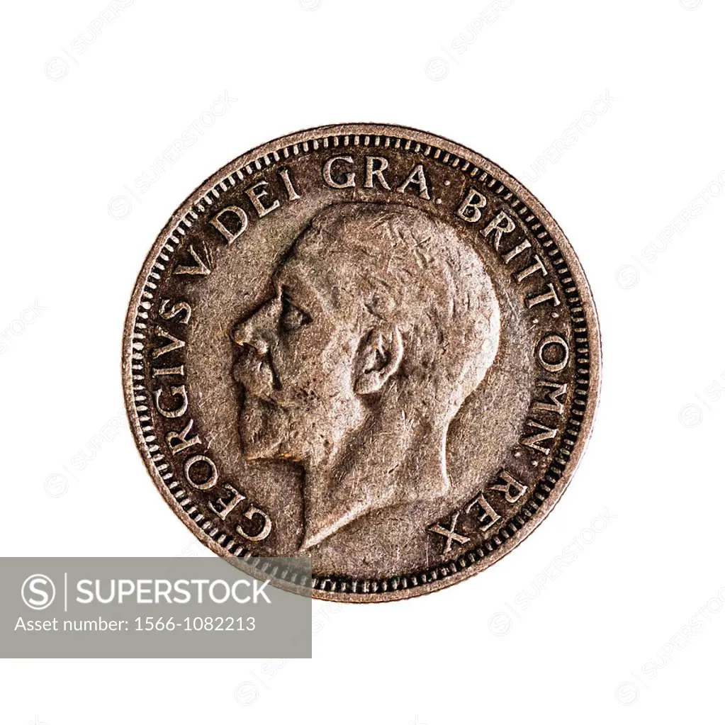 An English one shilling coin dated 1936 on a white background