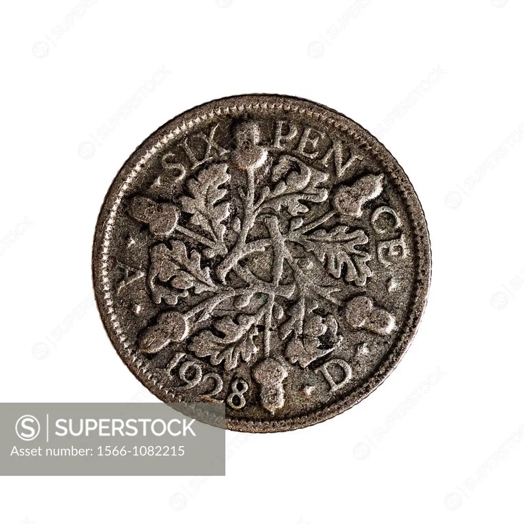 An English sixpence coin dated 1928 on a white background
