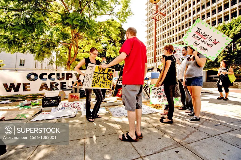 Protesters show new signs expressing the We-Are-the-99 anti-capitalism sentiments of Occupy Wall Street presence at Los Angeles City Hall in October, ...