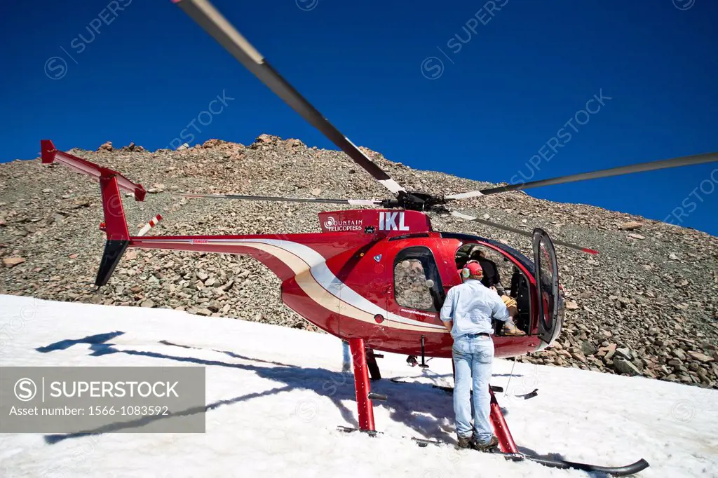 People and helicopter on peak of Mount Cook the highest mountain in New Zealand, reaching 3,754 meters  Mount Cook National Park, Southern Alps, South...