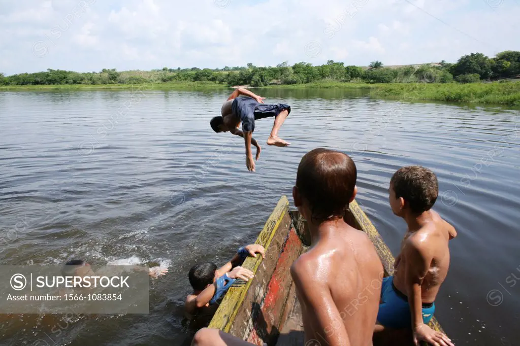 children swimming in river magdalana, colombia