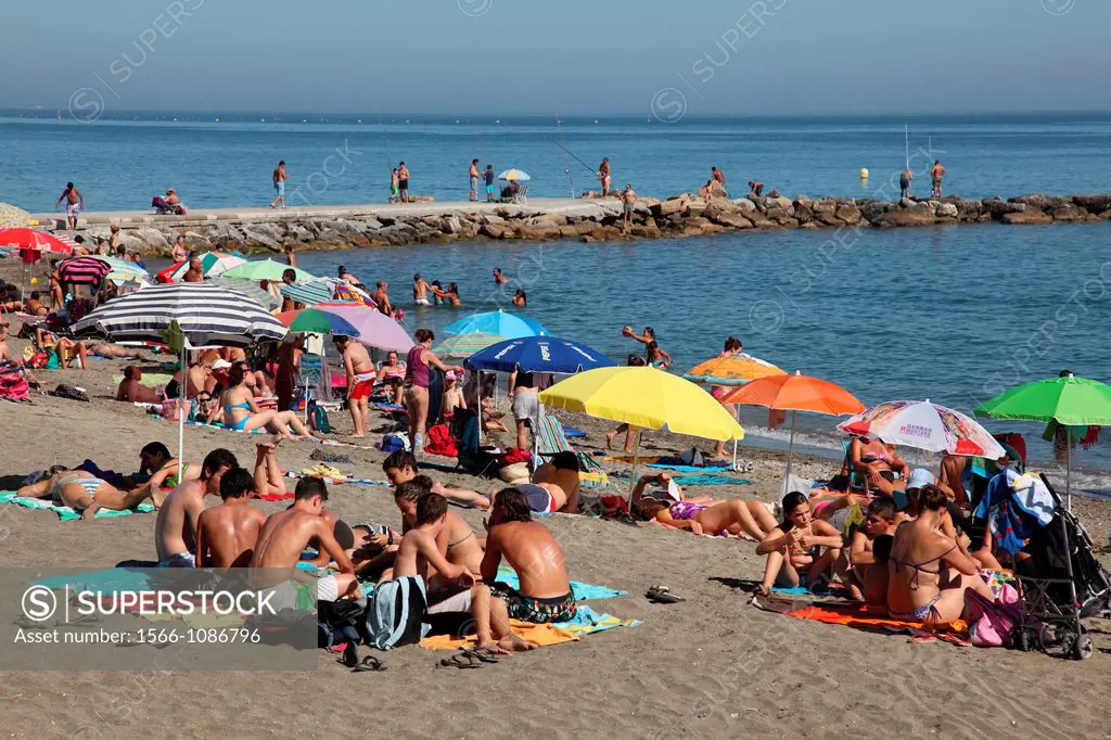 Tourists enjoy the beach in Marbella, Andalusia, Spain, Europe