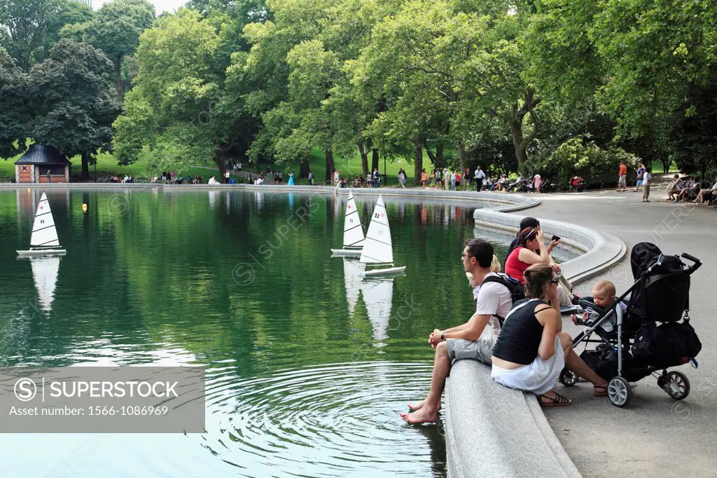 Visitors relax by the Lake in Central Park  Manhattan  New York City  USA.