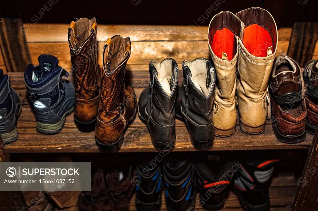 Boots and shoes on shelf.