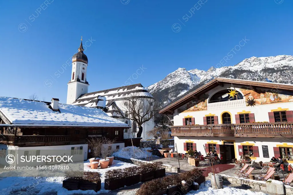 Garmisch-Partenkirchen during winter with the parish church of Sankt Martin, buildt between 1730 and 1734 and typical buildings of Garmisch Garmisch-P...