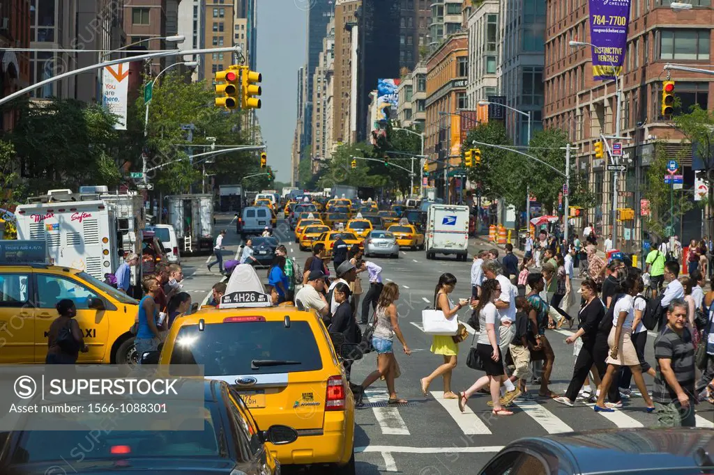 Traffic and pedestrians on crowded city streets in Manhattan in New York City