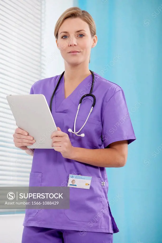 Female Nurse reviewing medical records on a tablet computer