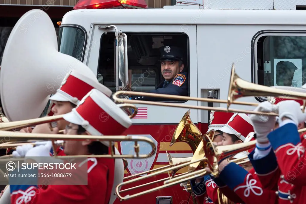 FDNY firefighter watches IS 318 marching band in the annual Three Kings Day Parade in the Bushwick neighborhood of Brooklyn on Sunday, January 8, 2012...