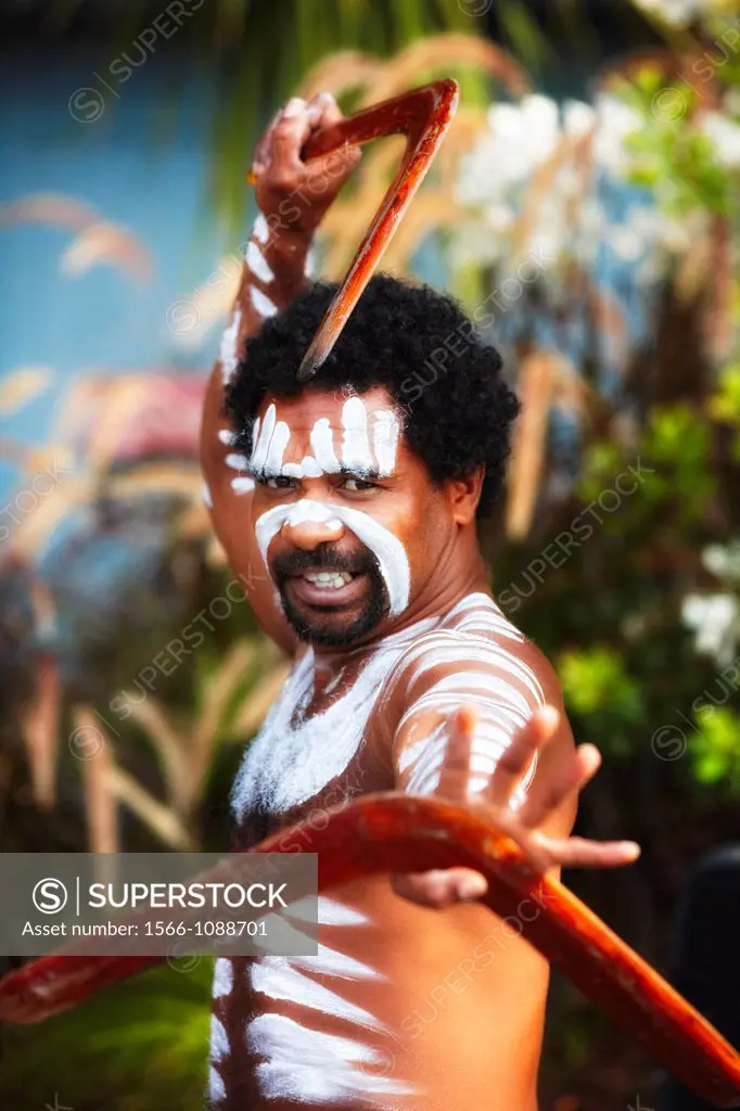 Aboriginal dancer posing with boomerangs, Australia