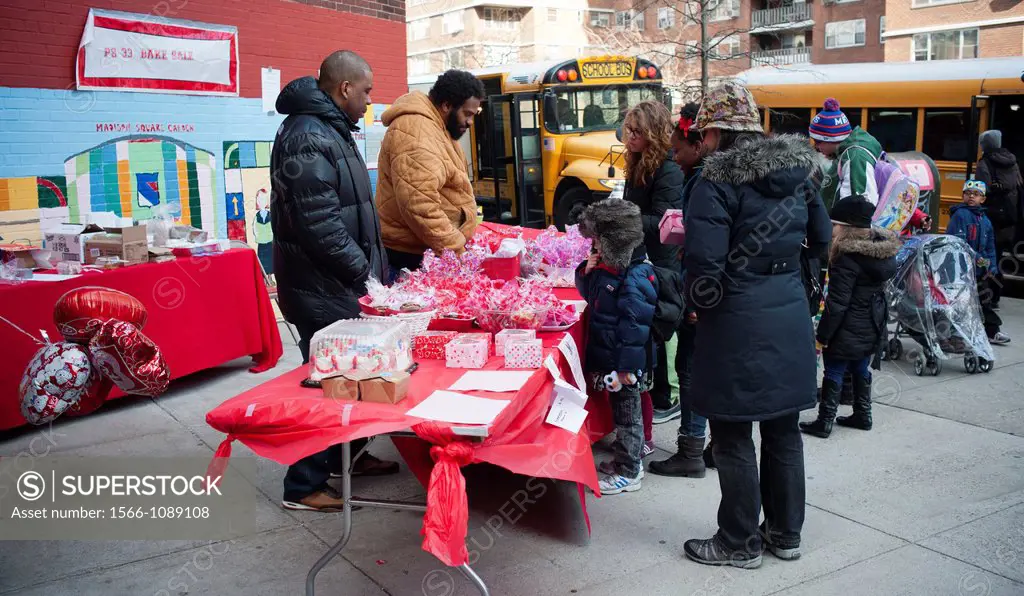 Volunteers man a bake sale fundraiser for PS 33 in the New York neighborhood of Chelsea on Valentine´s Day